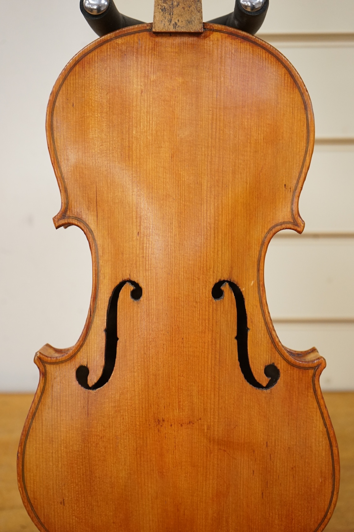 Three violins; a late 19th century German Stradivarius pattern violin, without label, a handmade violin (a.f.), with sound post crack, broken and repaired scroll, etc. and a Maidstone violin body, varnish stripped from t
